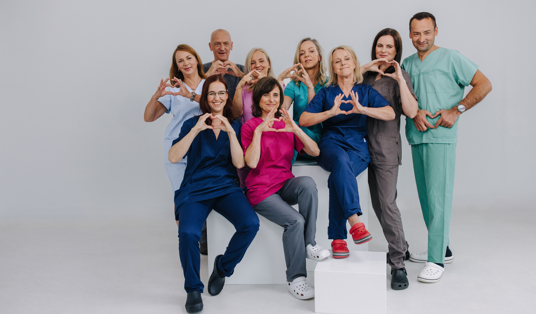 Team der Gemeinschaftspraxis für Anästhesie zeigt Herz und Zusammenhalt, Gruppenfoto in OP-Kleidung